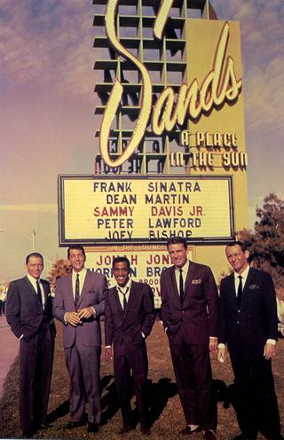A postcard shows the Rat Pack (from left Frank Sinatra, Dean Martin, Sammy Davis Jr., Peter Lawford and Joey Bishop) posing in front of a Sands Hotel marquee bearing their names. Their performances at the Sands during the 60s marked the golden age of the group.