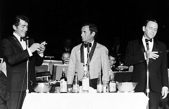 A collection of spirits accompanies Dean Martin, Joey Bishop, and Frank Sinatra as they perform together at the Copa Room of the Sands hotel-casino in 1966.