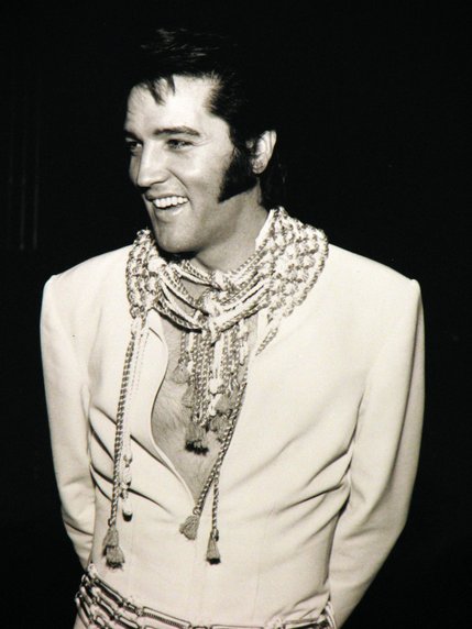 Elvis Presley smiles for photographers backstage after a concert in 1970 at the International Hotel.