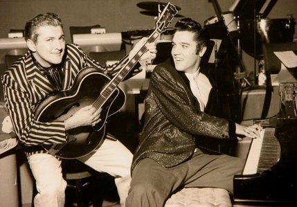 Liberace and Elvis Presley trade jackets and instruments in an impromptu jam session at the Riviera and Casino, on November 14, 1956.