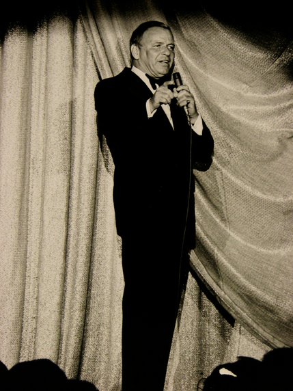 Frank Sinatra sings onstage at Caesars Palace during a June 1974 performance. Sinatra began performing at Caesars in 1968, after Howard Hughes' 1967 purchase of the Sands lead to a violent dispute with Sands hotel management over Sinatra's credit at the casino.