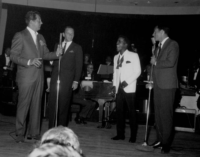 Sammy Davis Jr. roars with laughter as he and fellow Rat Pack members Dean Martin, Frank Sinatra and Joey Bishop perform together at the Sands' Copa Room during the 1960s.