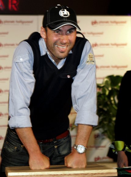 Boxer Joe Calzaghe of Wales makes imprints of his knuckles in clay.