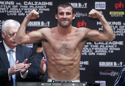 Joe Calzaghe of Wales flexes on the scale during his official weigh-in. 