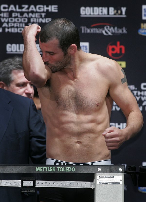 Joe Calzaghe of Wales kisses his bicep muscle during an ...