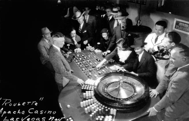 Gamblers enjoy a game of Roulette at the Apache Casino during the 1930's. During the construction of the Hoover Dam, the Apache was the stopover for many Hollywood celebrities including Clark Gable.