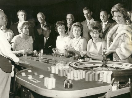 Guests try their luck at roulette while gambling at the Sands Hotel in this 1950s photograph. The hotel initially started off as a small casino with only a few hundred hotel rooms, but because of the resort's high-profile entertainment and attractions it became extremely popular. 