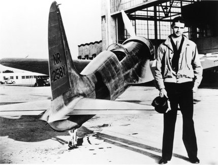 A young Howard Hughes stands next to his H-1 racer airplane in this 1930's photo. The H-1 was the first aircraft produced by Hughes Aircraft Corporation and Hughes would set the world airspeed record and break his own American transcontinental speed record in the H-1.