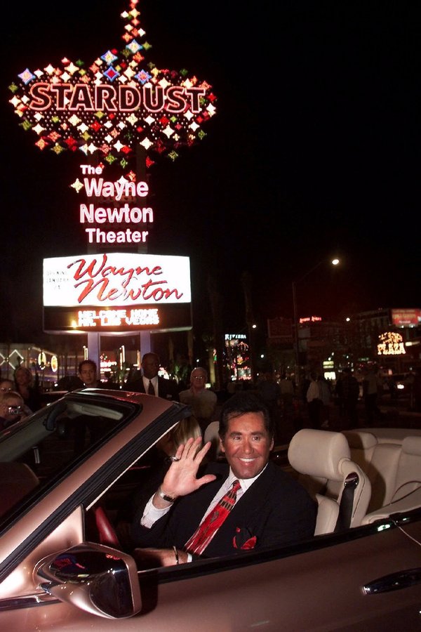 Entertainer Wayne Newton waves beneath the sign at the Stardust ...