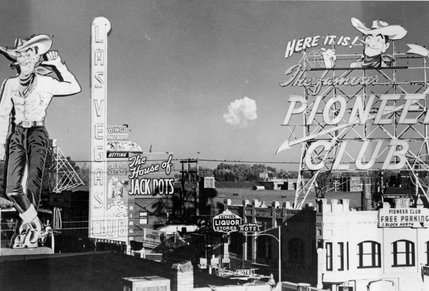 A mushroom cloud from a nuclear test appears on the horizon of downtown Las Vegas, November 1951.  Six atmospheric tests and one subterranean detonation were conducted for Operation Buster-Jangle at the Nevada Test Site in late 1951.