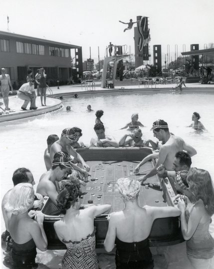 Guests at the Sands play Craps on a floating table inside of the resort's pool. The huge Sands pool offered tourists another option for daytime entertainment. Guests would swim and relax during the day, then gamble and watch shows at night. The hotel, however, was willing to accommodate those who wanted to multi-task.