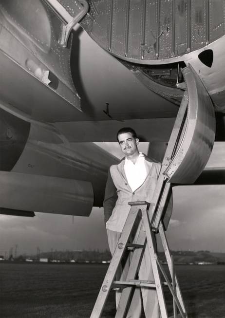 Howard Hughes stands below the second prototype of his XF-11 ...