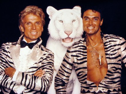 Siegfried & Roy pose with one of their famous White Tigers for a promotional shot advertising their show "Beyond Belief."