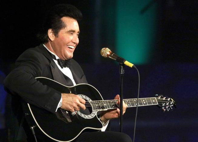 Wayne Newton plays a guitar during his millennium concert at the Stardust hotel-casino Friday Dec. 31, 1999. The Stardust named a showroom after Newton, in honor of a 10-year contract he signed with the hotel.
