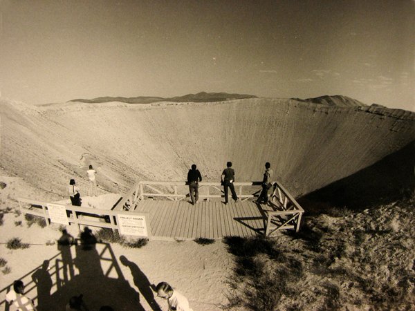 Members of the media survey Sedan crater. Detonated July 6, ...