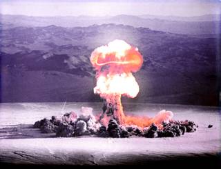 The Priscilla nuclear bomb is detonated over Frenchman Flat on June 24, 1957.  The test was one of a series of controversial nuclear tests codenamed Operation Plumbbob.   The 37 kiloton bomb was detonated at 700 feet above the valley floor via hot air balloon. Operation Plumbbob sought to take advantage of the nuclear tests with training exercises, war games and lectures for military personnel on how the atom bomb would change the way wars would be fought, culminating in the actual explosions every 5 days during the late spring and summer of 1957.