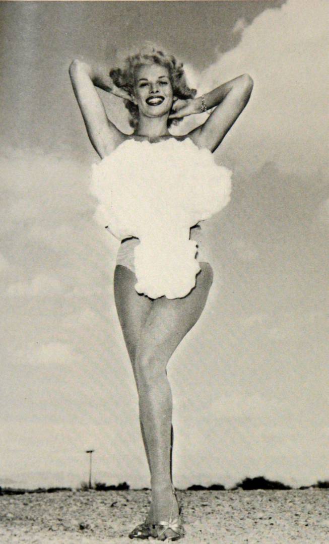 Copa Room showgirl Lee Merlin poses in a cotton mushroom cloud swimsuit as she is crowned Miss Atomic Bomb in this 1957 photograph. Above-ground nuclear testing was a major public attraction during the late 1950s, and hotels capitalized on the craze by hosting nuclear bomb watch parties, which usually included the dubbing of a chorus girl as Miss Atomic Bomb. Merlin was the last and most famous of the Miss Atomic Bomb girls.