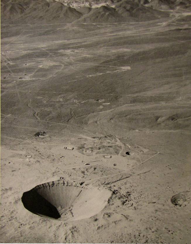 The Sedan Crater was formed when a 104-kiloton explosive buried under 635 feet of desert rock and soil was fired at the Nevada Test Site on July 6, 1962, displacing 12 million tons of earth.  The crater is 320 feet deep and has a diameter of about 1,280 feet. The radioactive cloud rose 12,000 feet in the air and headed east then northeast toward the Mississippi River. The crater shown is listed on the National Register of Historic Places. 