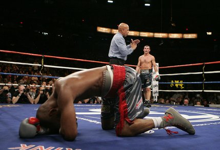 Referee Joe Cortez calls timeout after Joe Calzaghe hit Bernard Hopkins with a low blow during their fight at the Thomas and Mack Center.