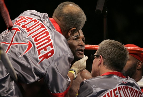 Trainers tend to Bernard Hopkins between rounds.