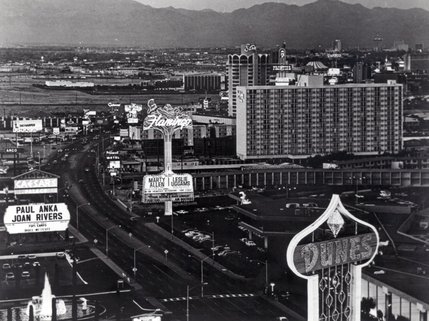 The late 1970's Strip. Culturally the city was going through a golden age with books and movies set in its environs, but new investment lagged as the city reeled from the loss of traffic from LA due to the 1973 oil crisis. Kirk Kerkorian is largely credited with maintaining the city's growth, opening the International Hotel and signing Elvis Presley then opening the MGM Grand Hotel. After Atlantic City legalized gambling in 1976 and swooped up the majority of east coast gaming business, few thought the region would grow much beyond its 1980 population of around 450,000.