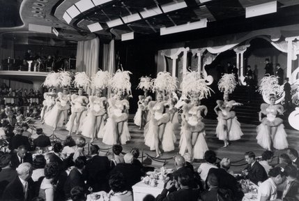 Showgirls of the "Lido de Paris" entertain audiences of the Stardust.  The extravagant revue featured an on-stage waterfall, six hydraulic stages, an ice rink and a swimming pool. It was also the first stage show (outside of burlesque) that featured topless performers.