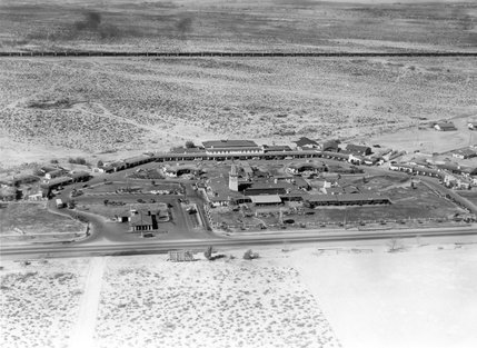 The El Rancho Vegas awaits commuters on Highway 91 (which would later become The Strip) in this late 1940s photo. The El Rancho was the first hotel casino on The Strip to offer gaming, lodging and dining in one location. A long train car can be seen in the distance heading toward downtown.  At the time, the economy of Las Vegas was still reliant on the railroad between Salt Lake City and Los Angeles.
