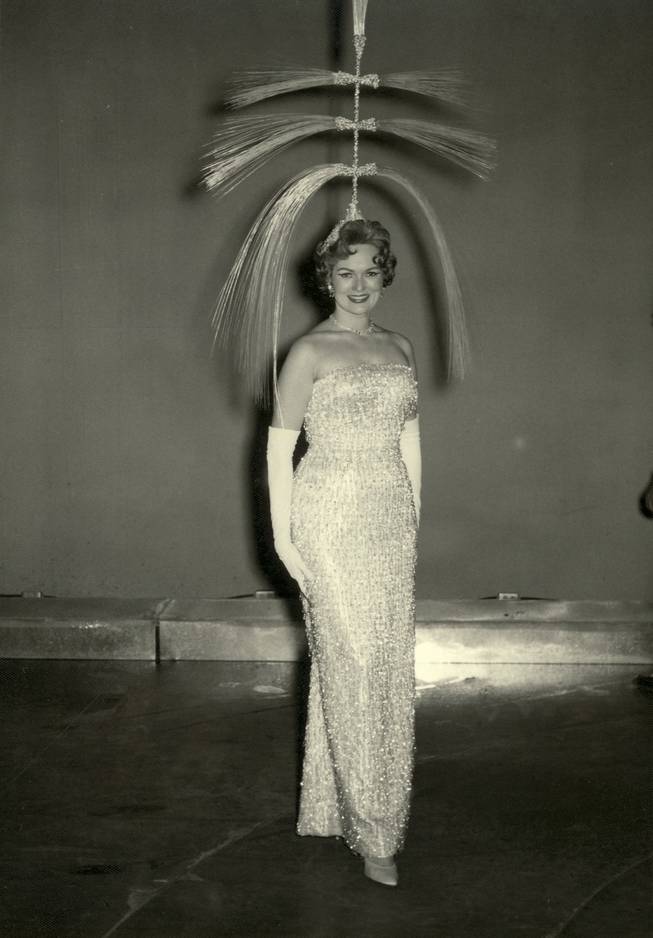 A burlesque dancer showcases an extravagant headpiece as part of a "Minsky Folies" performance at the Dunes Hotel. The Minsky Folies was the first topless show offered by a hotel in the state of Nevada.