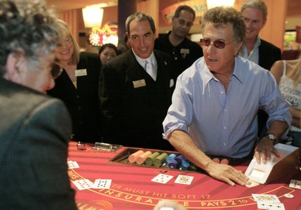 Actor Dustin Hoffman deals a card to actor Elliot Gould, during the CineVegas International Film Festival celebrity blackjack tournament at the Palms hotel Saturday, June 15, 2002. Hoffman later accepted the festival's inaugural Marquee Award. The award honors an actor who has an impressive body of work in both independent and mainstream films. 