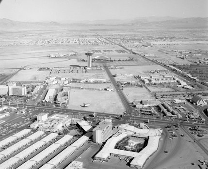 The first iteration of the Las Vegas Convention Center, a flyng saucer-inspired circular building with a shiny metal roof, can bee seen in this March 2, 1965 aerial shot of Las Vegas. In front of it is the incomplete 31-story Landmark Hotel. Early suburban development can also be seen in the distance.