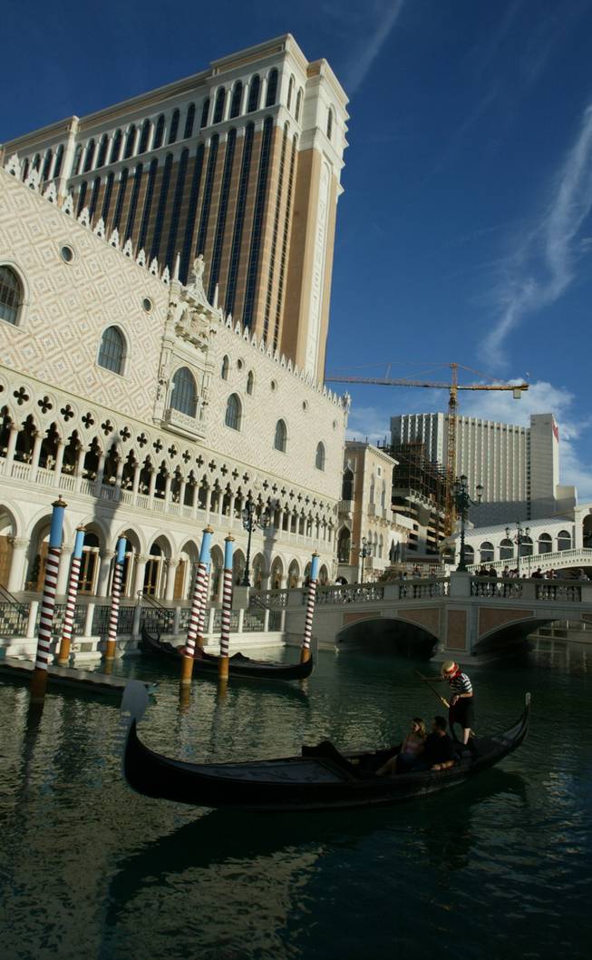 Tourists are treated to a Gondola ride in front of The Venetian Hotel on the Las Vegas Strip. The gondoliers often sing while transporting guests in true Venice fashion. 