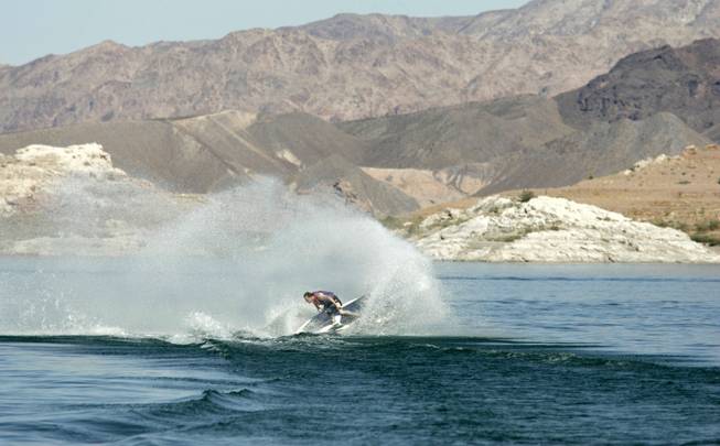Despite declining water levels, Kris Verville still finds enough water to kick up with his jet ski at Lake Mead on Oct. 6, 2004. Lake Mead is currently over half full, and its water level dropped approximately 80 feet between 1999 and 2006.