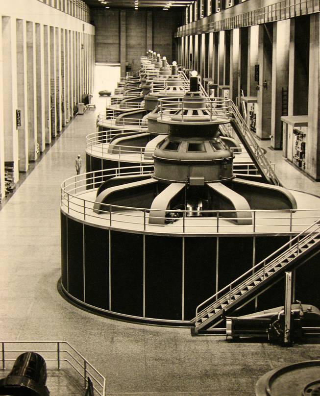 This photo, taken Aug 18, 1981, shows a row of generators lining the inside of the Hoover Dam power plant. At center are the tops of some of the turbines which generate the massive electric power created when water pours down through the turbines. It produces  2,080 megawatts of electrical power, enough to meet the needs of 1 million to 1.5 million people for a year.