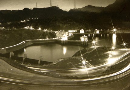A time lapse photo from the north-east side of Hoover Dam shows traffic moving across the dam at night. The Federal Highway Administration estimates that each day as many as 17,000 people cross the dam on U.S. Highway 93. 