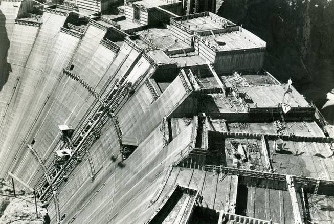 Workers are shown pouring concrete at Hoover Dam. Refrigerated water ...