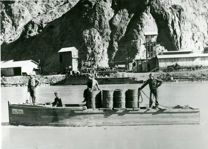A boat is shown floating downstream behind the Hoover Dam in this Jan. 10, 1932 photo. Boats are often used to transport men and supplies up and down the canyon during construction.