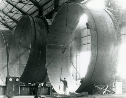 A man stands inside of a penstock pipe, used during the construction of the Hoover Dam. The 30-foot diameter pipes dwarf the worker, and shows the grand scale of the project. In fact, there is enough concrete inside the dam to pave a two-lane highway from San Francisco, Calif. to New York, N.Y.