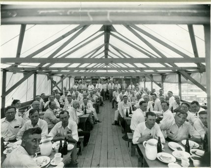 Workers dine at the mess hall during construction of the Hoover Dam. The Boulder City Construction company hired the Anderson Brothers Supply Company to feed the workers. By 1936, the brothers served approximately 7,400,000 meals, averaging over 4,300 per day. 