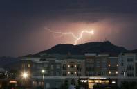 A lightning bolt strikes behind Black Mountain and the District at Green Valley Ranch during a July 17, 2006 thunderstorm. 
