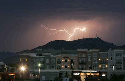 A lightning bolt strikes behind Black Mountain and the District at Green Valley Ranch during a July 17, 2006 thunderstorm. 