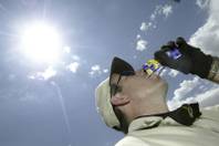 Scott Cadger of Southwest Gas takes a drink while working out in the heat in Southwest Las Vegas on Aug. 2, 2004. Cadger, who was installing a gas meter at a new home, keeps himself hydrated while working the majority of his shift outside in the heat.