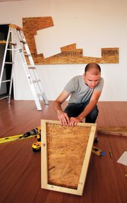 RC Wonderly installs a piece at the Main Gallery. Wonderly often plays with geometric forms, especially cubes, and spatial relationships.

