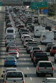 Motorists navigate rush hour traffic on Interstate 15 in Clark County. Rep. Jon Porter, who opposed tougher fuel efficiency standards two years ago, more recently has taken the position that Congress should act against global warming.