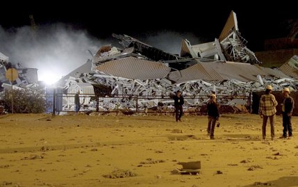 Workers look over debris from the final buildings of the former Desert Inn after they were imploded early Tuesday, Nov. 16, 2004, to make way for a second planned hotel tower adjacent to the Wynn Las Vegas. The $2.4 billion first phase of the megaresort is scheduled to open April 28, 2005. 