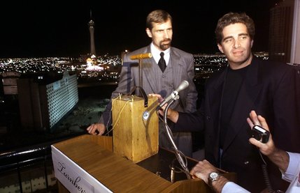 Henry Nichols, left, a partner in the El Rancho acquisition, and Turnberry Place developer Jeffrey Soffer, listen to instructions from Controlled Demolition Inc. president Mark Loizeaux (not pictured) as they prepare to symbolically press down a plunger to implode the 13-story hotel-casino early Tuesday morning, October 3, 2000. The building, which belongs to Florida-based Turnberry Associates and has been vacant since 1992, was imploded by Las Vegas-based LVI Environmental Services Inc. and Maryland-based CDI. Turnberry Associates is currently building Turnberry Place, a $600 million high-rise condominium project, adjacent to the doomed El Rancho, but no plans for the land where the hotel sat have been announced. 
