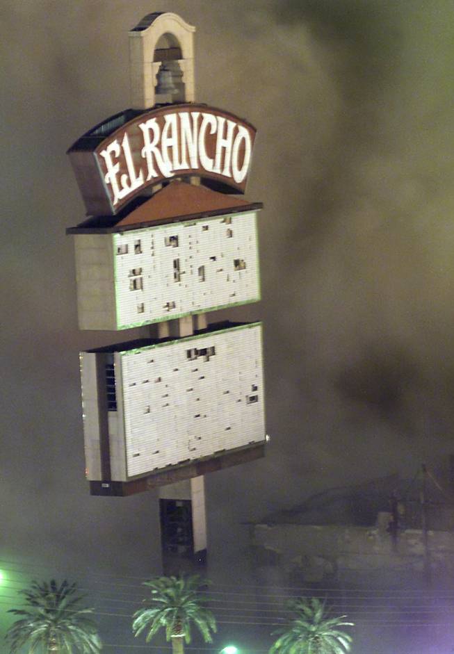 A cloud of dust billows around the El Rancho sign after the hotel-casino was imploded early Tuesday, Oct. 3, 2000. Even though Turnberry Place now covers the original sign, the El Rancho is still clearly seen.