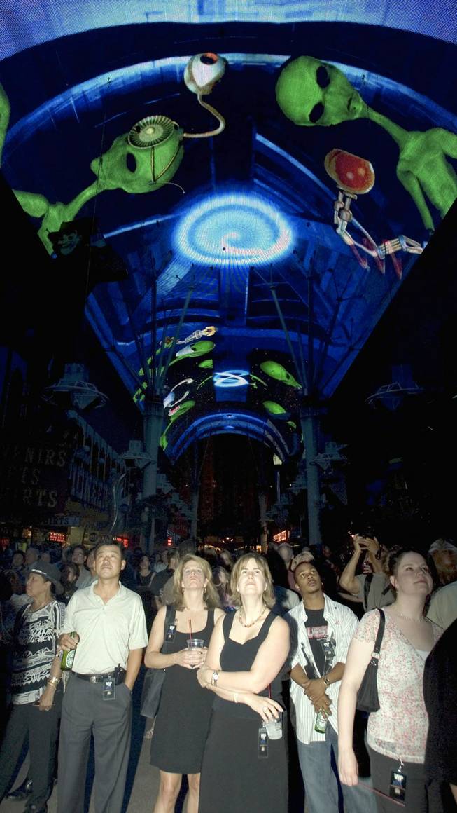 Guests watch &#8220;Area 51,&#8221; at the Fremont Street Experience Light and Sound Show Monday, June 14, 2004.  &#8220;Area 51&#8221; was one of two shows that premiered after the $17 million upgrade to the Light and Sound Show &#8220;Viva Vision.&#8221; The upgrade included the installation of 12.5 million LED lights on Fremont Street's 90-foot high, 500-yard long canopy.