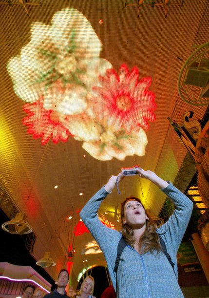 Sasha Rodriguez of San Diego uses a digital camera to take a video during the light show at the Fremont Street Experience Sunday, Nov. 3, 2002. The canopy is 90-feet tall, and spans 1,400-feet from Main Street to 4th Street.