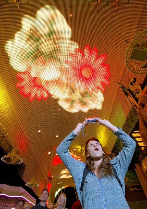 Sasha Rodriguez of San Diego uses a digital camera to ...