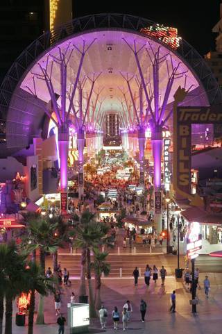 The Fremont Street Experience glows under its canopy as thousands of tourists patronize the businesses and casinos located on the historic street.